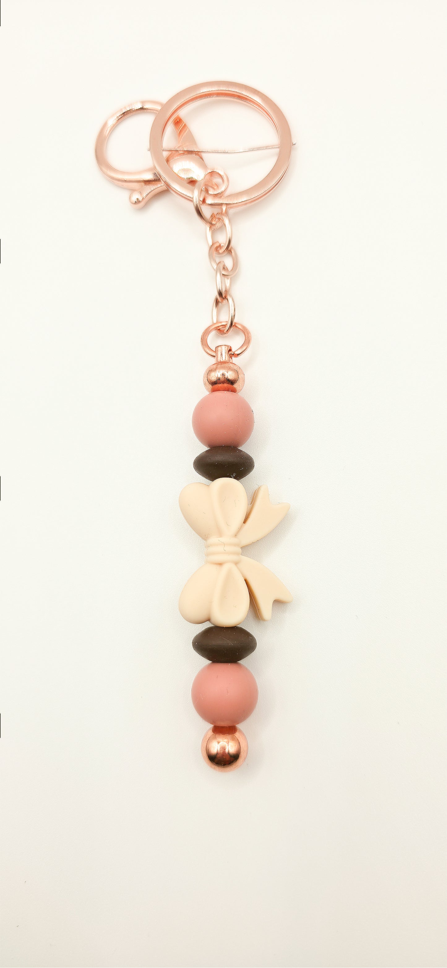Keychain with pink beads and a bow on a white background
